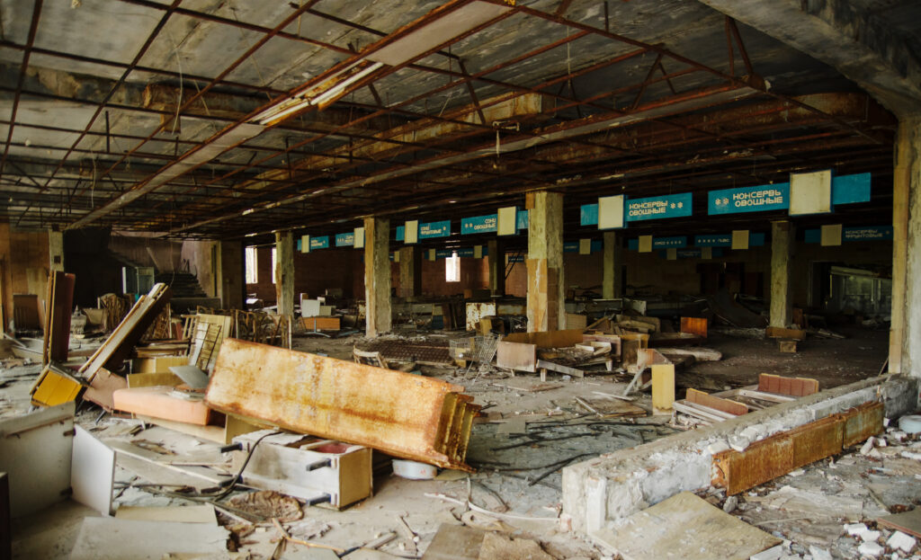 supermarket shop at chernobyl exclusion zone with ruins of aband